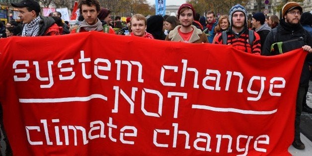 PARIS, FRANCE - DECEMBER 12: Activists stage a demonstration near the Arc de Triomphe at the Avenue de la Grande Armee boulevard in Paris on December 12, 2015. A proposed 195-nation accord to curb emissions of the heat-trapping gases that threaten to wreak havoc on Earth's climate system is to be presented at the United Nations conference on climate change COP21 in Le Bourget, on the outskirts of Paris. (Photo by Mustafa Yalcin/Anadolu Agency/Getty Images)