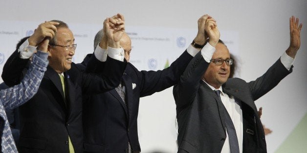 (L-R) Secretary General of the United Nations Ban Ki Moon, Foreign Affairs Minister and President-designate of COP21 Laurent Fabius, and France's President Francois Hollande raise hands together after adoption of a historic global warming pact at the COP21 Climate Conference in Le Bourget, north of Paris, on December 12, 2015. Envoys from 195 nations on December 12 adopted to cheers and tears a historic accord to stop global warming, which threatens humanity with rising seas and worsening droughts, floods and storms. AFP PHOTO / FRANCOIS GUILLOT / AFP / FRANCOIS GUILLOT (Photo credit should read FRANCOIS GUILLOT/AFP/Getty Images)