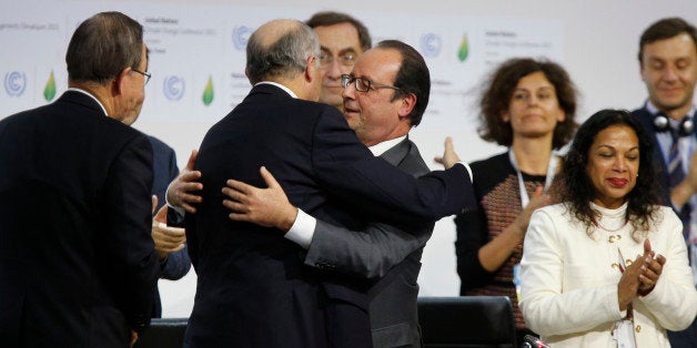 Foreign Affairs Minister and President-designate of COP21 Laurent Fabius (2-L) and France's President Francois Hollande (C) hug after the adoption of a historic global warming pact at the COP21 Climate Conference in Le Bourget, north of Paris, on December 12, 2015. Envoys from 195 nations on December 12 adopted to cheers and tears a historic accord to stop global warming, which threatens humanity with rising seas and worsening droughts, floods and storms. AFP PHOTO / FRANCOIS GUILLOT / AFP / FRANCOIS GUILLOT (Photo credit should read FRANCOIS GUILLOT/AFP/Getty Images)