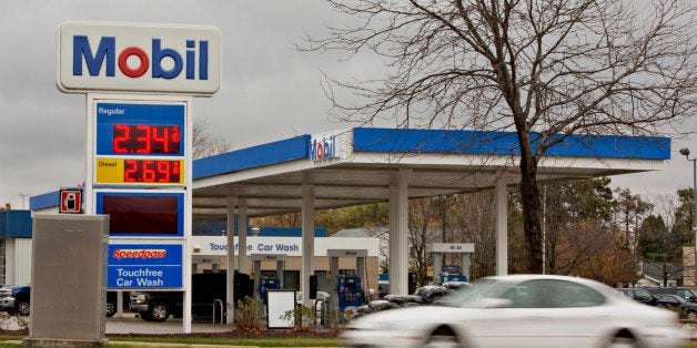 A vehicle drives past an Exxon Mobil Corp. gas station in Rockford, Illinois, U.S., on Wednesday, Oct. 28, 2015. Exxon Mobil Corp. is scheduled to report quarterly earnings on October 30. Photographer: Daniel Acker/Bloomberg via Getty Images