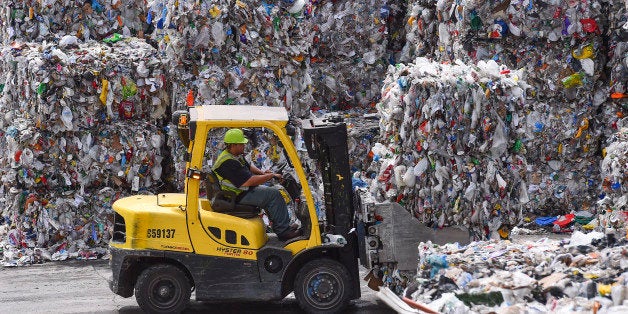 ELKRIDGE, MD - JUNE 18: A forklift operator is seen stacking bales of recyclables at the Waste Management Elkridge Material Recycling Facility on June 18, 2015 in Elkridge, Md. D.C. and other local jurisdictions send their recyclable materials to the Waste Management facility in Elkridge for recycling. The cardboard and paper products are baled and shipped to China for new product production. The facility is a one thousand ton facility, where it takes in a thousand tons and sends out a thousand tons daily. (Photo by Ricky Carioti/The Washington Post via Getty Images)