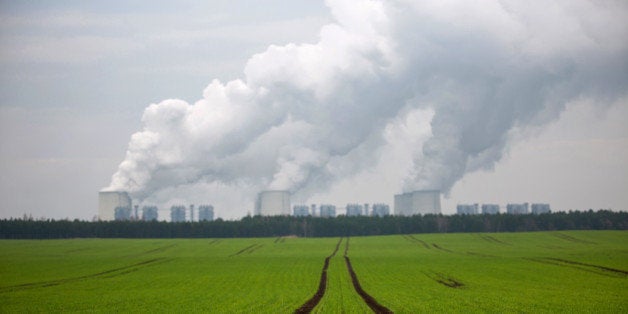 Chimneys emit vapor beyond agricultural land at Jaenschwalde lignite power plant, operated Vattenfall AB, in Peitz, Germany,