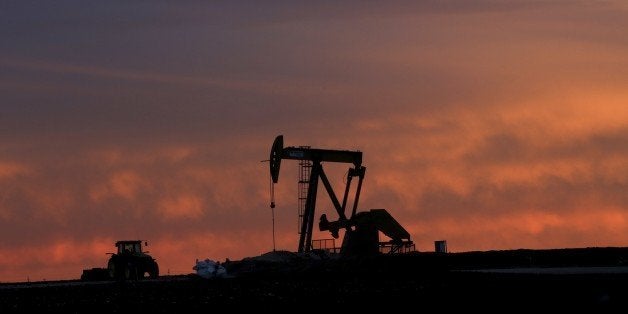 In this photo made Monday, Dec. 22, 2014, a well pump works at sunset on a farm near Sweetwater, Texas. At the heart of the Cline, a shale formation once thought to hold more oil than Saudi Arabia, Sweetwater is bracing for layoffs and budget cuts, anxious as oil prices fall and its largest investors pull back. (AP Photo/LM Otero)