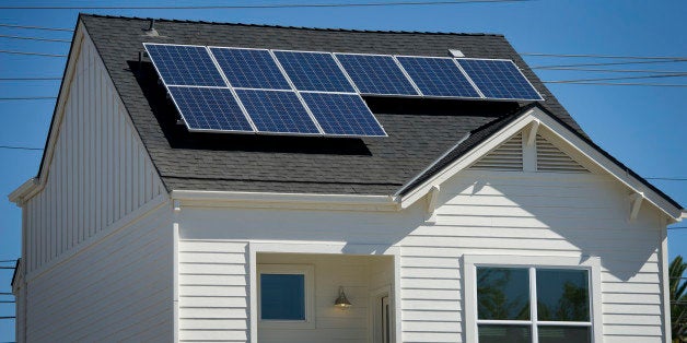 Solar panels sit on the roof of the model home at the Pacific Housing Inc. 2500 R Midtown housing development site in Sacramento, California, U.S., on Thursday, Sept. 5, 2013. With a plan for 34 detached single family homes, 2500 R Midtown, will be a net zero energy community. Photographer: David Paul Morris/Bloomberg via Getty Images