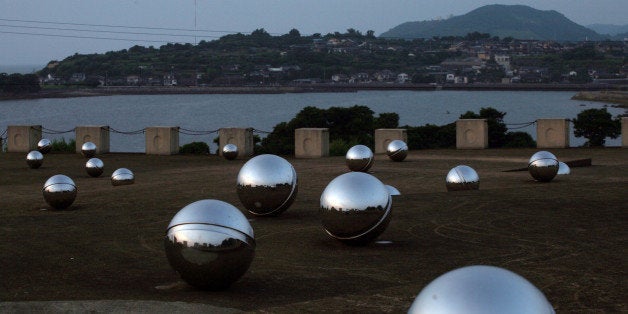 A memorial for those who died or were sickened by mercury poisoning rests on a hill overlooking the town of Minamata, Japan a