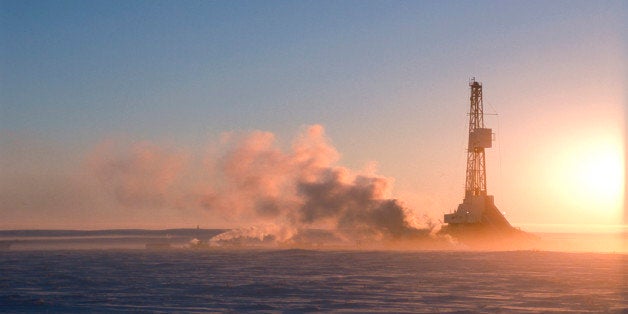 Oil drilling north of the Arctic Circle near Tuktoyaktuk, Northwest Territories, Canada with the sun rising up at dawn