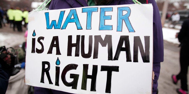 FLINT, MI - FEBRUARY 19: People gather in front of a church before participating in a national mile-long march to highlight the push for clean water in Flint February 19, 2016 in Flint, Michigan. The march was organized in part by Rev. Jesse Jackson. (Photo by Bill Pugliano/Getty Images)