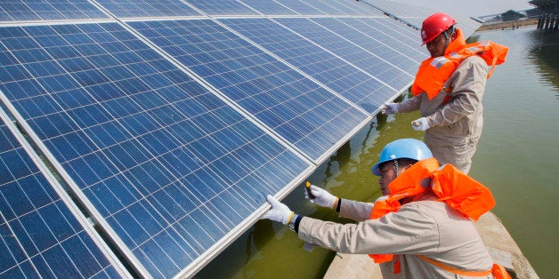 LIANYUNGANG, CHINA - MARCH 16: (CHINA OUT) Electricians take a boat to inspect the solar panels in a fishing pond on March 16, 2016 in Lianyungang, Jiangsu Province of China. A 150,000-square-meter photovoltaic station including over 40,000 solar panels built in a fishing pond began to make electricity in Lianyungang. (Photo by ChinaFotoPress/ChinaFotoPress via Getty Images)