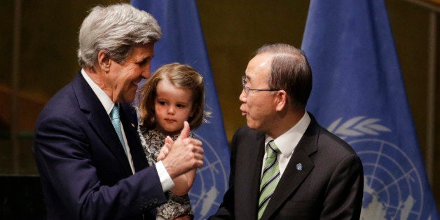 U.S. Secretary of State John Kerry holds his granddaughter Isabel Dobbs-Higginson as he talks to Secretary General Ban Ki-moon after signing the Paris Agreement on climate change, Friday, April 22, 2016 at U.N. headquarters. (AP Photo/Mark Lennihan)