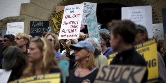 Protesters call for a ban on fracking and a phasing out of oil development in California, in Santa Barbara, California, United States, May 21, 2015. As much as 2,500 barrels (105,000 gallons) of crude oil, according to latest estimates, gushed onto San Refugio State Beach and into the Pacific west of Santa Barbara when an underground pipeline running parallel to a coastal highway there inexplicably burst on Tuesday morning. REUTERS/Lucy Nicholson