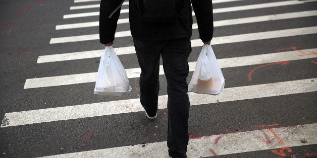 NEW YORK, NY - MAY 05: A man walks out of a store with a plastic bags on May 05, 2016 in New York City. New York's City Council is scheduled to vote Thursday on a bill that would require most stores to charge five cents per bag in an effort to cut down on plastic waste. New York's sanitation department estimates that every year 10 billion bags are thrown in the trash. (Photo by Spencer Platt/Getty Images)