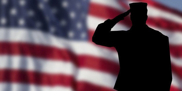 Soldier saluting the USA flag for memorial day