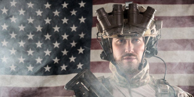 Portrait of Bearded US Army Soldier With Night Vision Goggles on American Flag Background; Smoke Cloud