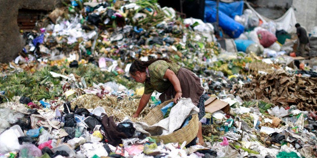 A woman searches for food at the garbage dump of the La Terminal food centre, one of the largest food markets in Guatemala City February 27, 2015. REUTERS/Jorge Dan Lopez (GUATEMALA - Tags: SOCIETY FOOD)