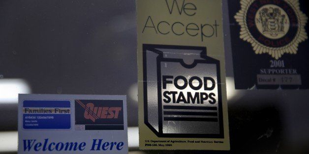 A supermarket displays stickers indicating they accept food stamps in West New York, N.J., Monday, Jan. 12, 2015. New Jersey lawmakers are considering a bill that would require the state to expedite the handling of applications for food stamps. (AP Photo/Seth Wenig)