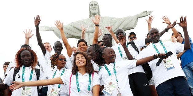 2016 Rio Olympics - Christ the Redeemer - 30/07/2016. Members of the Olympic refugee team including Yusra Mardini from Syria (C) pose in front of Christ the Redeemer. REUTERS/Kai Pfaffenbach 