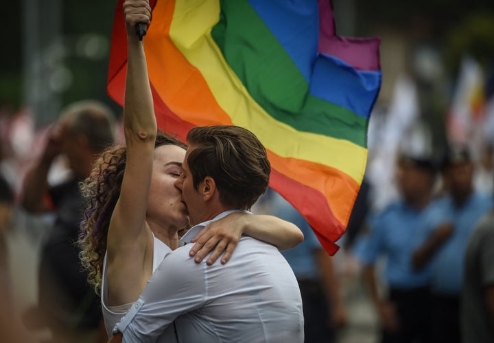 Two women kiss as they take part in the Bucharest Pride 2018 March on June 9.