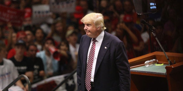 AUSTIN, TX - AUGUST 23: Republican Presidential nominee Donald Trump watches as a protester is ejected on August 23, 2016 in