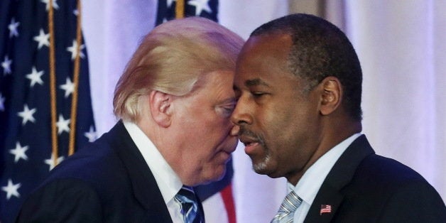 Republican U.S. presidential candidate Donald Trump (L) walks behind former Republican presidential candidate Ben Carson (R) after receiving Carson's endorsement at a campaign event in Palm Beach, Florida March 11, 2016. REUTERS/Carlo Allegri