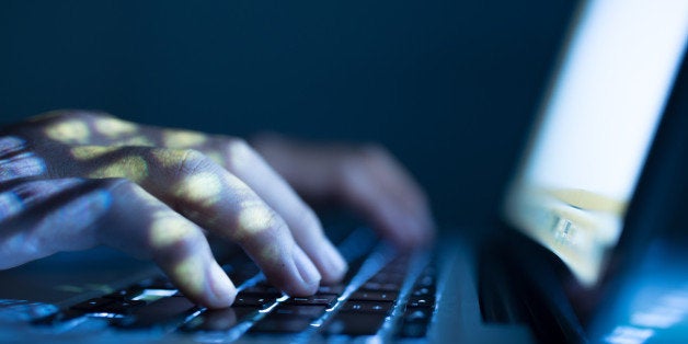 Close-up image of software engineer typing on laptop