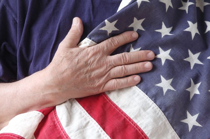 a man's hand on a usa flag...