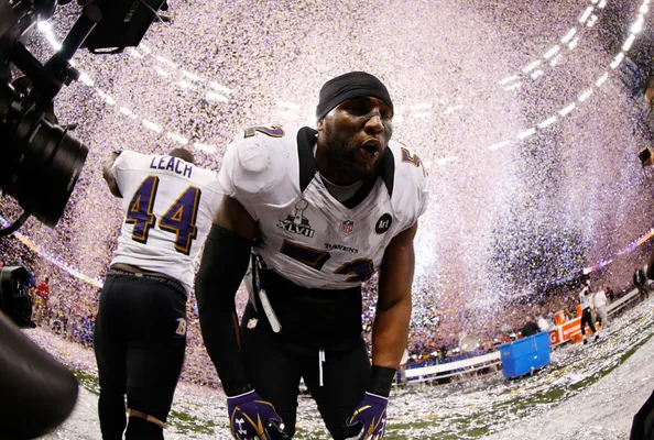 Raven's Chykie Brown makes confetti snow angel after Super Bowl victory 