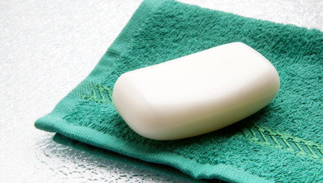 White soap bar on double towel