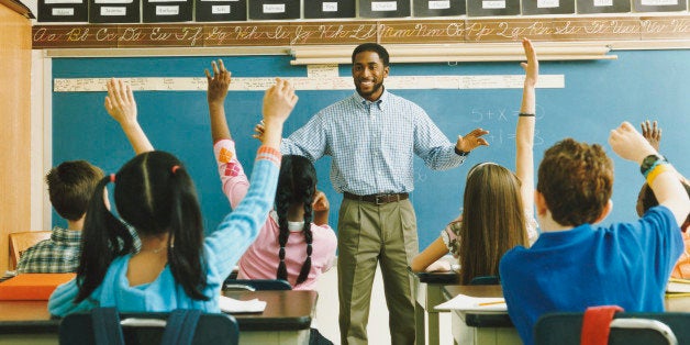 Teacher Standing in Front of a Class of Raised Hands