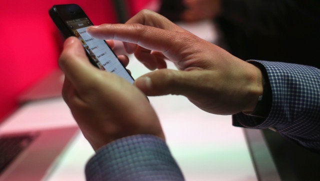 NEW YORK, NY - MARCH 26: A T-Mobile connected iPhone 5 is shown on display after John Legere, CEO and President of T-Mobile USA made an announcement during an event about new contract pricing on March 26, 2013 in New York City. Legere confirmed that T-Mobile will start carrying the iPhone 5 starting April 12, under it's new no-contract plan called The Simple Choice, with the customers paying $99 down, then $20 a month for 24 months, on top of the monthly service plan. (Photo by John Moore/Getty Images)