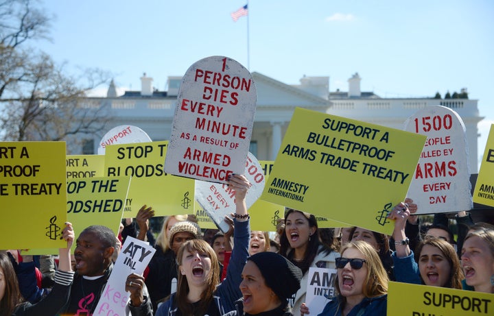 Demonstrators from Amnesty International chant outside the White House in Washington, DC, March 22, 2013, as they protest cal