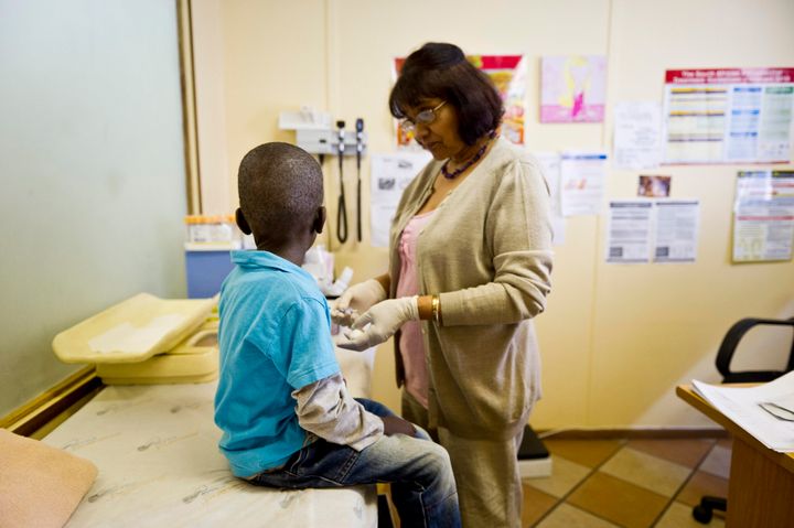 JOHANNESBURG, SOUTH AFRICA - JANUARY 27: (SOUTH AFRICA OUT) Sister Sally Naidoo administers an HIV test on a young boy at the Right To Care AIDS clinic on January 27, 2012 in Johannesburg, South Africa. The Right to Care non-governmental organisation has, with US funding from PEPFAR managed to revive their Alexandra based AIDS clinic.The clinic is now providing quality medical treatment to more than 8000 patients. (Photo by Foto24/Gallo Images/Getty Images)