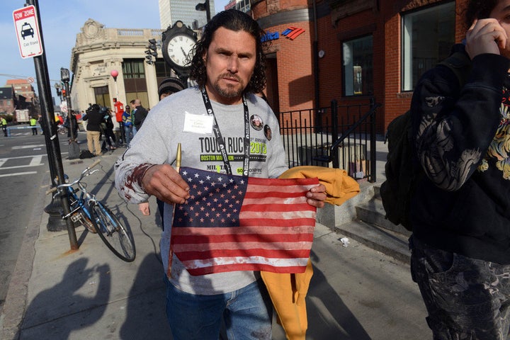 BOSTON, MA - APRIL 15: Carlos Arredondo, who was at the finish line of the 117th Boston Marathon when two explosives detonated, leaves the scene on April 15, 2013 in Boston, Massachusetts. Two people are confirmed dead and at least 28 injured after at least two explosions went off near the finish line to the marathon. (Photo by Darren McCollester/Getty Images)