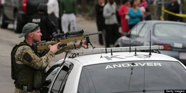 WATERTOWN, MA - APRIL 19: S.W.A.T. teams conduct a house to house search in an area near last night's shootout during the ongoing manhunt for a suspect in the terrorist bombing of the 117th Boston Marathon earlier this week. (Photo by Barry Chin/The Boston Globe via Getty Images)