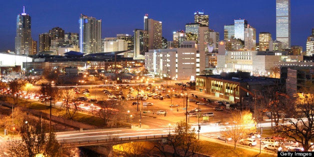 Rush hour traffic zipping in front of the Denver skyline.