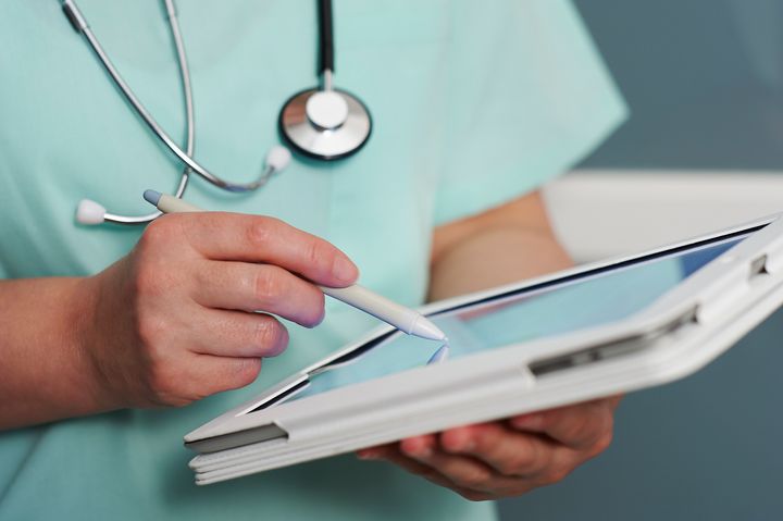 Healthcare professional using tablet computer