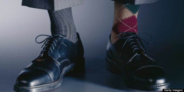 Man wearing mismatched socks, low section, close-up