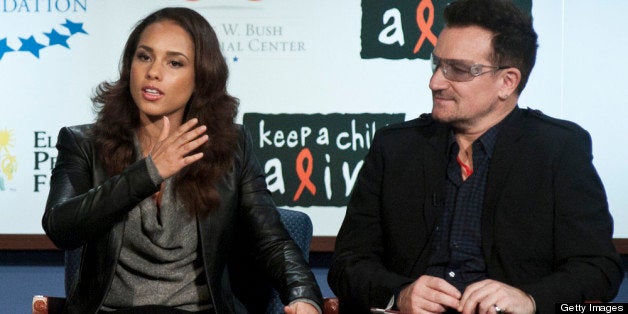 WASHINGTON, DC - DECEMBER 01: Alicia Keys and Bono speak during the 2011 World AIDS Day discussion at George Washington University on December 1, 2011 in Washington, DC. (Photo by Kris Connor/Getty Images)