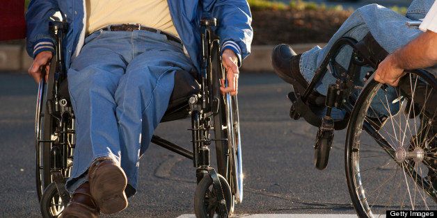 Man with Friedreich's Ataxia greeting his friend with spinal cord injury