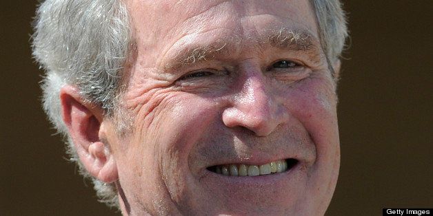 Former US President George W. Bush smiles during the George W. Bush Presidential Center dedication ceremony in Dallas, Texas, on April 25, 2013. (Photo credit should read JEWEL SAMAD/AFP/Getty Images)
