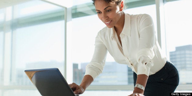 Businesswoman working on laptop in office