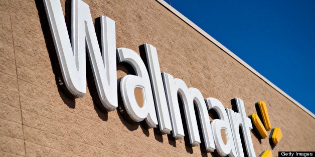 A sign hangs outside a Wal-Mart store in East Peoria, Illinois, U.S., on Wednesday, Feb. 20, 2013. Wal-Mart Stores Inc., the world?s largest retailer, projected first-quarter profit that trailed analysts? estimates as an increase in the payroll tax and delayed refunds curtail spending by its lower-income shoppers. Photographer: Daniel Acker/Bloomberg via Getty Images
