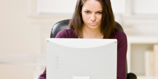 Hispanic businesswoman looking at computer
