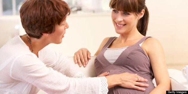 Pregnant woman talking to midwife