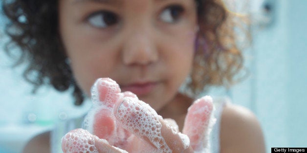 young girl washing her hands