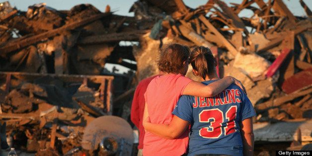 MOORE, OK - MAY 22: Christine Jones (L) is comforted by her daughter Ashley as they stand in front of Christine's home which was destroyed when a tornado ripped through the area on May 22, 2013 in Moore, Oklahoma. The tornado of at least EF4 strength and two miles wide touched down May 20 killing at least 24 people and leaving behind extensive damage to homes and businesses. U.S. President Barack Obama promised federal aid to supplement state and local recovery efforts. (Photo by Scott Olson/Getty Images)