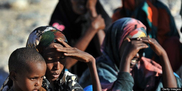 TO GO WITH AFP STORY BY OTTO BAKANOSomali women wait on December 2, 2010 for relief supplies from the UN High Commission for Refugees in Galkacyo, Somaliland. Each year tens of thousands of Ethiopians and Somalis make the perilous crossing to Yemen in the hope of a better life away from home, where economic deprivation, persecution and conflict have devastated their lives. Many of them die on the way on board the often overcrowded and rotten small boats, while others, already weakened by long journeys from the hinterland to the coast, die in the hands of ruthless smugglers. while unrest is uprooting families in Somalia, hundreds of others are fleeing from neighbouring Ethiopia due to economic hardship. AFP PHOTO / TONY KARUMBA (Photo credit should read TONY KARUMBA/AFP/Getty Images)