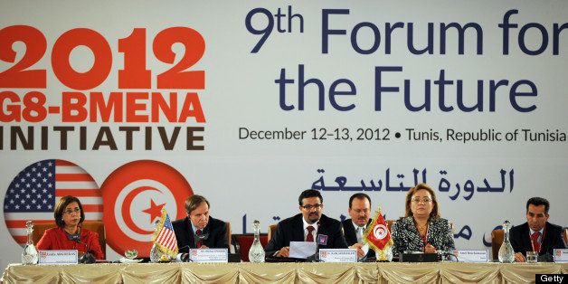 Michael H. Posner, US Assistant Secretary of State Bureau of Democracy, Human Rights and Labor, (2nd-L) and Tunisian Foreign Minister Rafik Abdessalem (C) address the 9th Forum for the Future in Tunis on December 13, 2012. The yearly forum is a centerpiece of the G8 Broader Middle East and North Africa (BMENA) partnership which represents cooperation between G8 countries and BMENA. AFP PHOTO/FETHI BELAID (Photo credit should read FETHI BELAID/AFP/Getty Images)