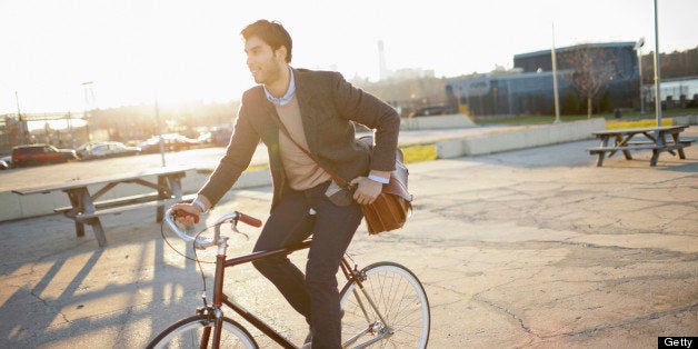 Man riding bicycle on city street