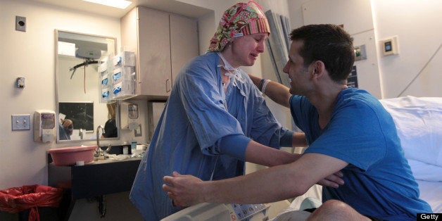 BOSTON - MAY 29: In tears, CRNA Amanda Heidbreder hugs Boston Marathon bombing victim Marc Fucarile, in his hospital room at MGH before he left for Spaulding Rehabilitation Hospital. (Photo by Bill Greene/The Boston Globe via Getty Images)