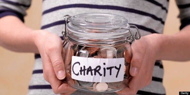 10 year old holding charity donations in a jar